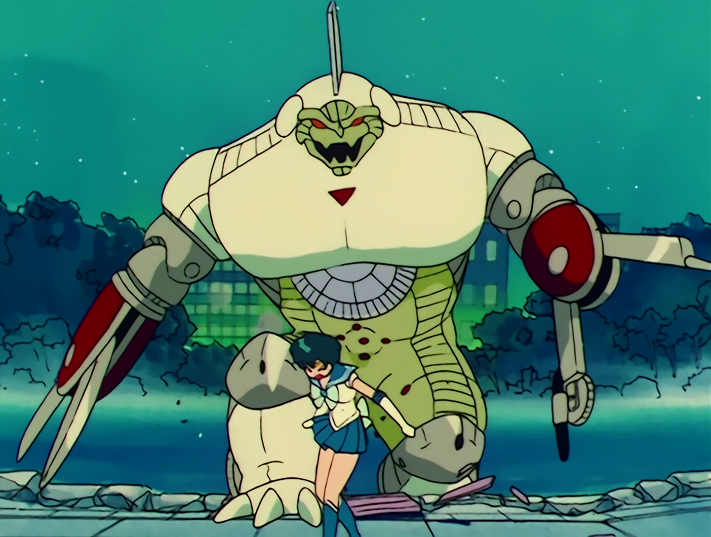 Bunbo, a Youma from Sailor Moon episode 27. Ugh, how do I even describe this guy? He’s enormous, stocky, mostly white and green, and patterned like a protractor. His arms look like Swiss Army knives, but with compasses instead of knives. The drawing kind of compasses, not the navigation kind. Do people still use those? Anyway, he’s chasing Sailor Mercury.